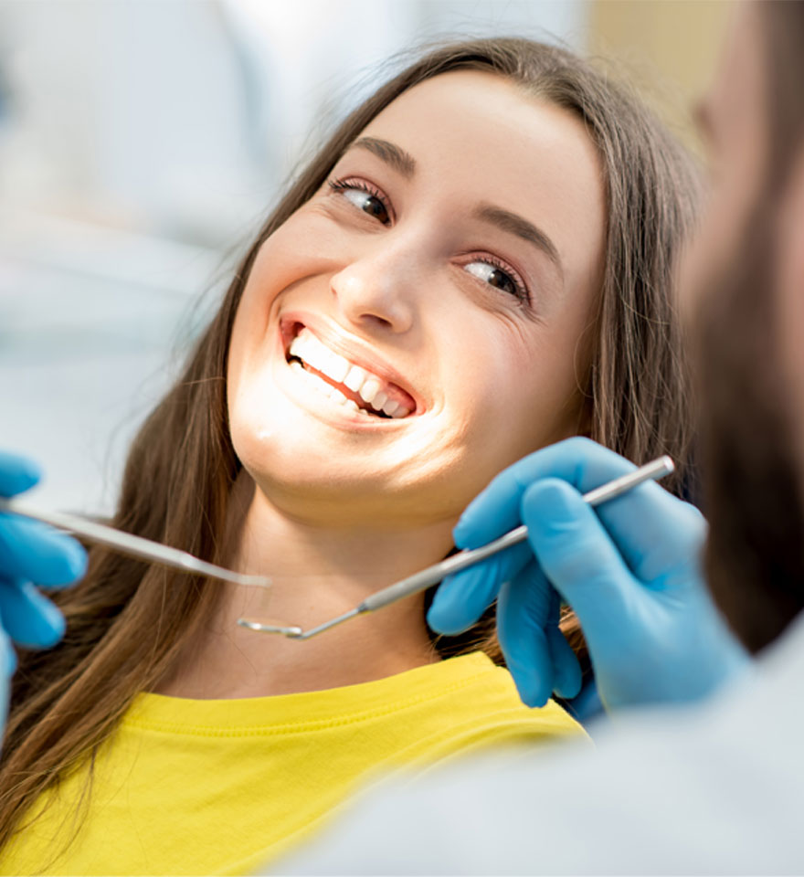 Happy patient with a bright smile during a dental check-up at Northdene Dental in Guildford