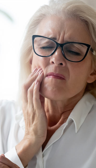 Patient experiencing toothache before emergency dental treatment